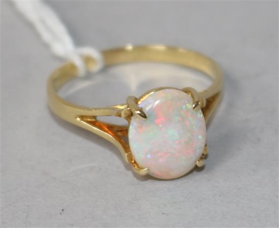 An 18ct gold and white opal ring, size P.